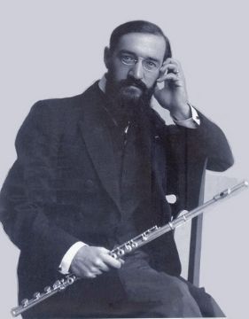 A photo of Georges Barrère holding his flute