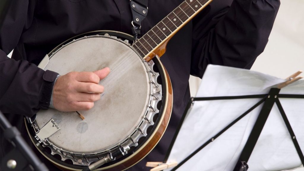 A person playing a banjo made from one of the best banjo brands