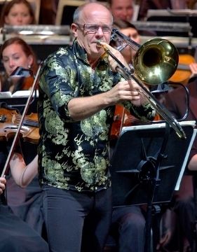 Famous trombone player Christian Lindberg playing the trombone on stage. 