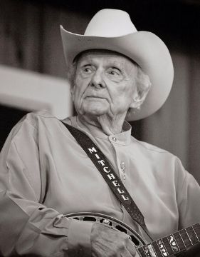 A black and white photo of banjo player Ralph Stanley