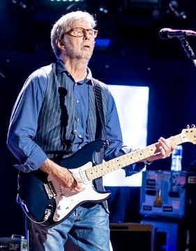 guitarist and singer Eric Clapton playing his guitar.