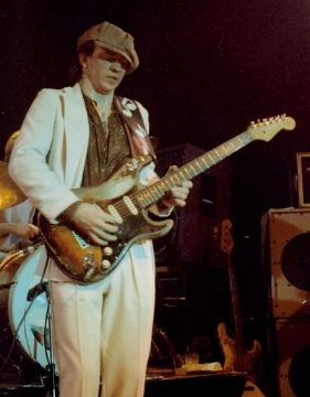 Stevie Ray Vaughan, one of the best guitarists of all time, playing on stage.