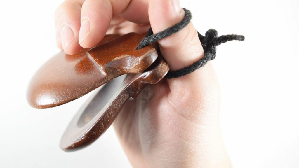 A hand playing the castanets