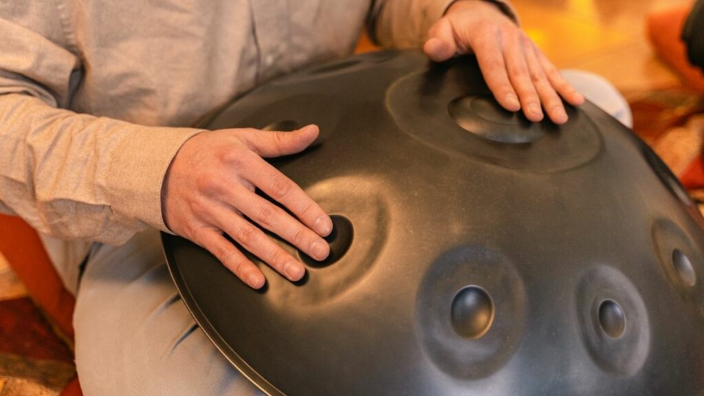 A person playing a handpan