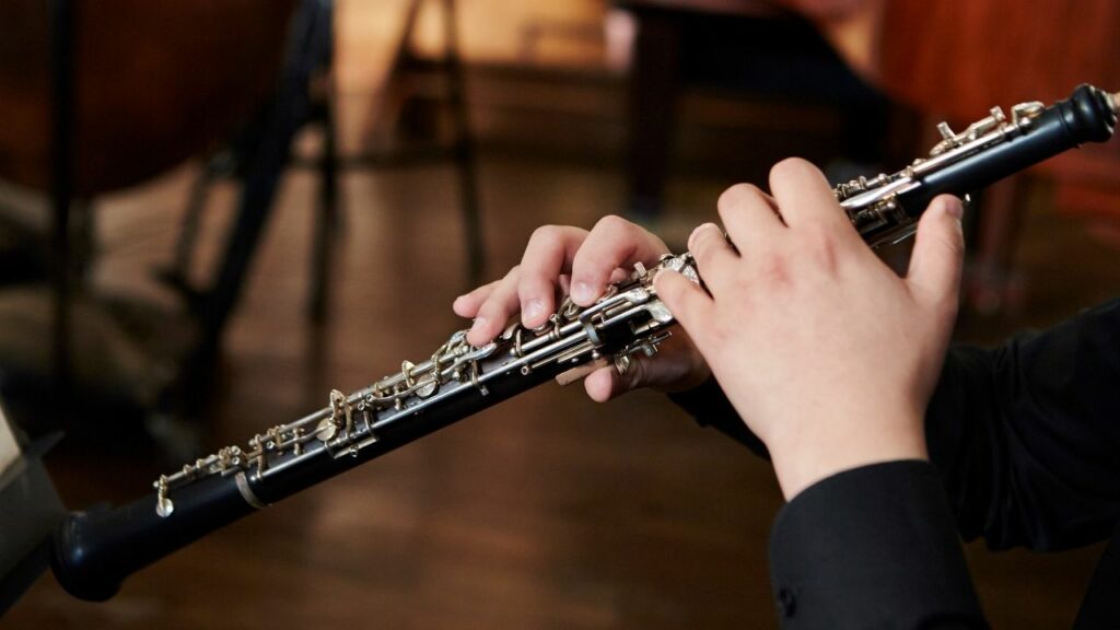 A musician holding an oboe