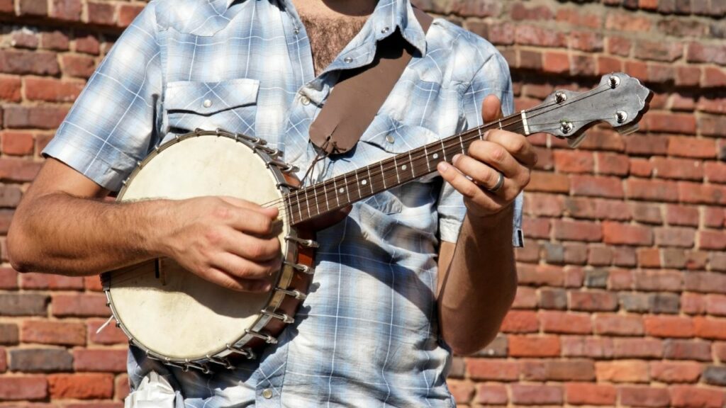 A person playing a 5-string banjo