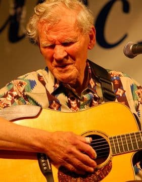 photo of blind singer, Doc Watson playing the guitar