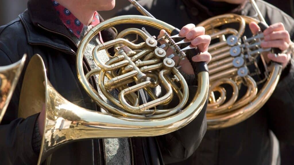 Musicians playing a french horn