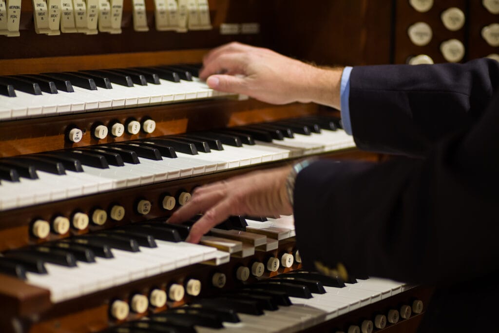 Close Up View Of A Organist Playing A Pipe Organ