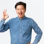 confident Asian man winking OK Shutterstock
