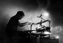 Drummer Playing The Drums With Smoke And Powder In The