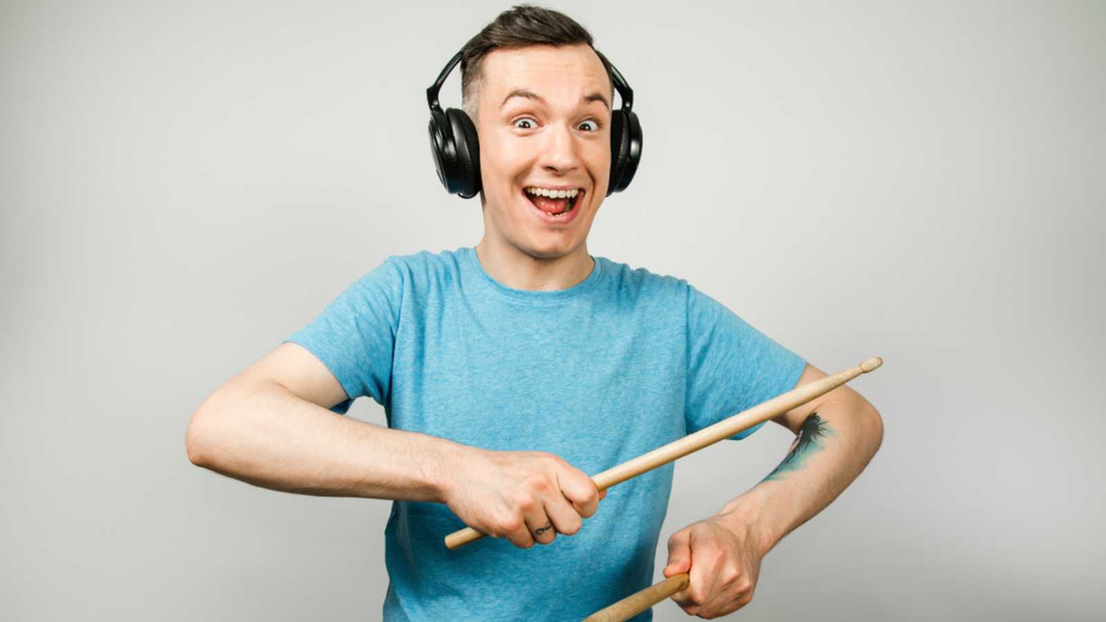 Man Hearing Music With Drumsticks
