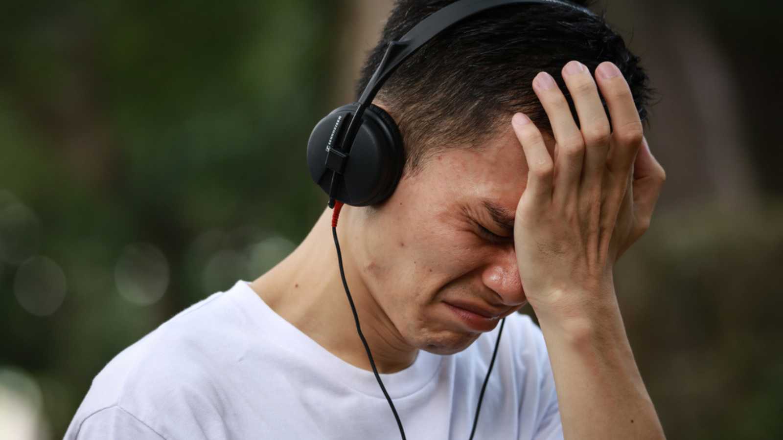 Man Crying While Listening To Music
