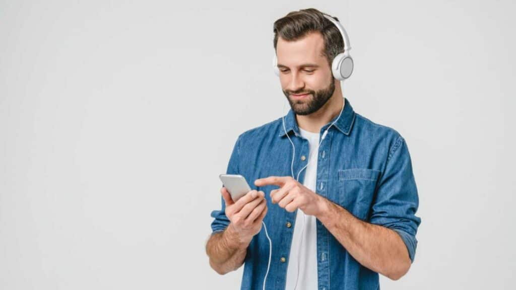 Man Listening To Music choosing songs in mobile