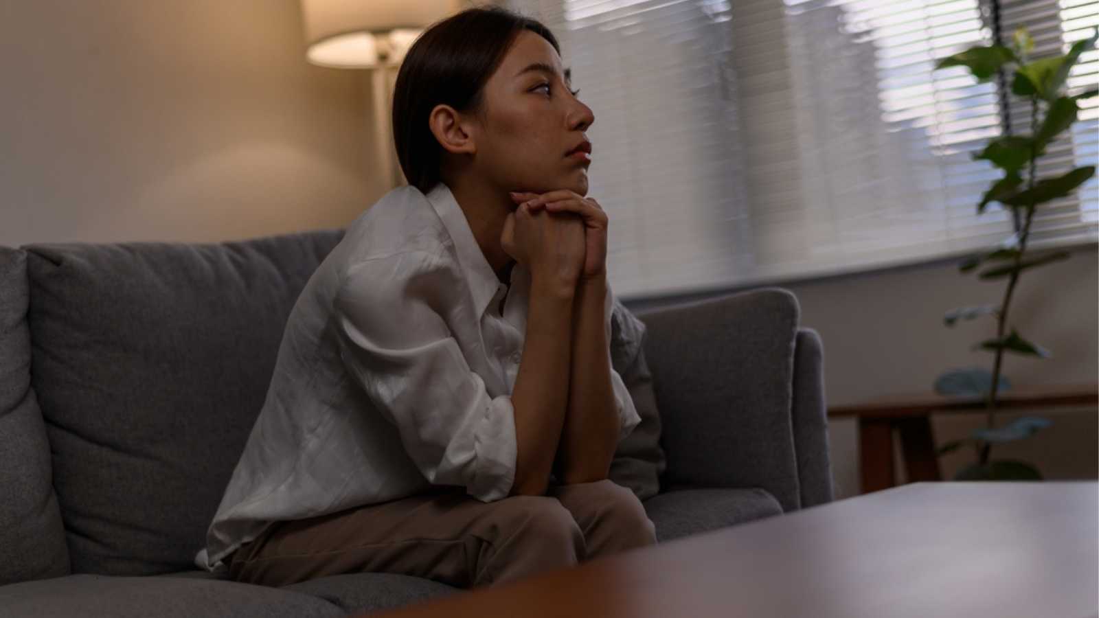 Sad Woman Sitting In Sofa