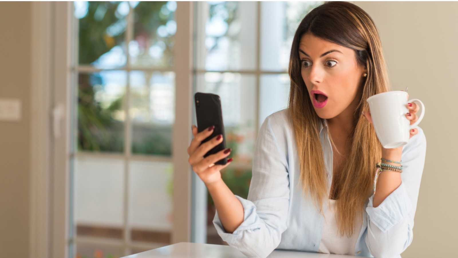 Woman watching mobile and thrilled