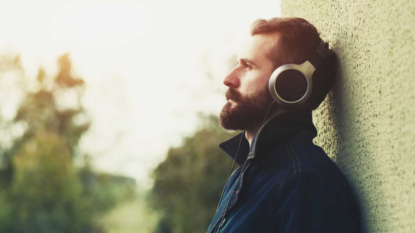 Stylish Bearded Man In Headphones Listening To Music