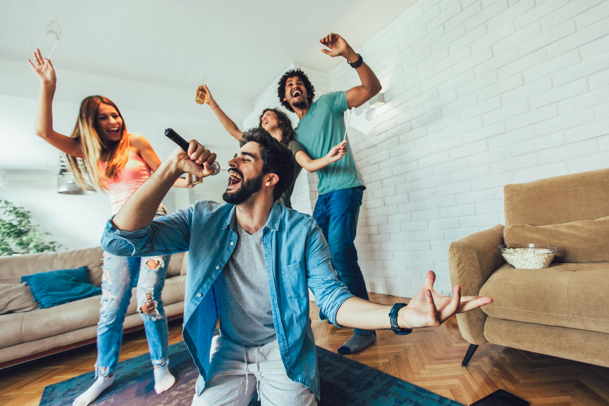 Group Of Friends Playing Karaoke At Home. Concept About Friendship 