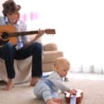 Father playing guitar for his son