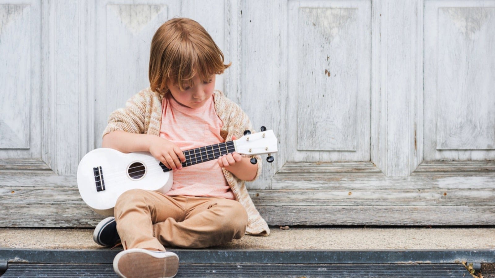 Little Happy Boy Playing With Guitar