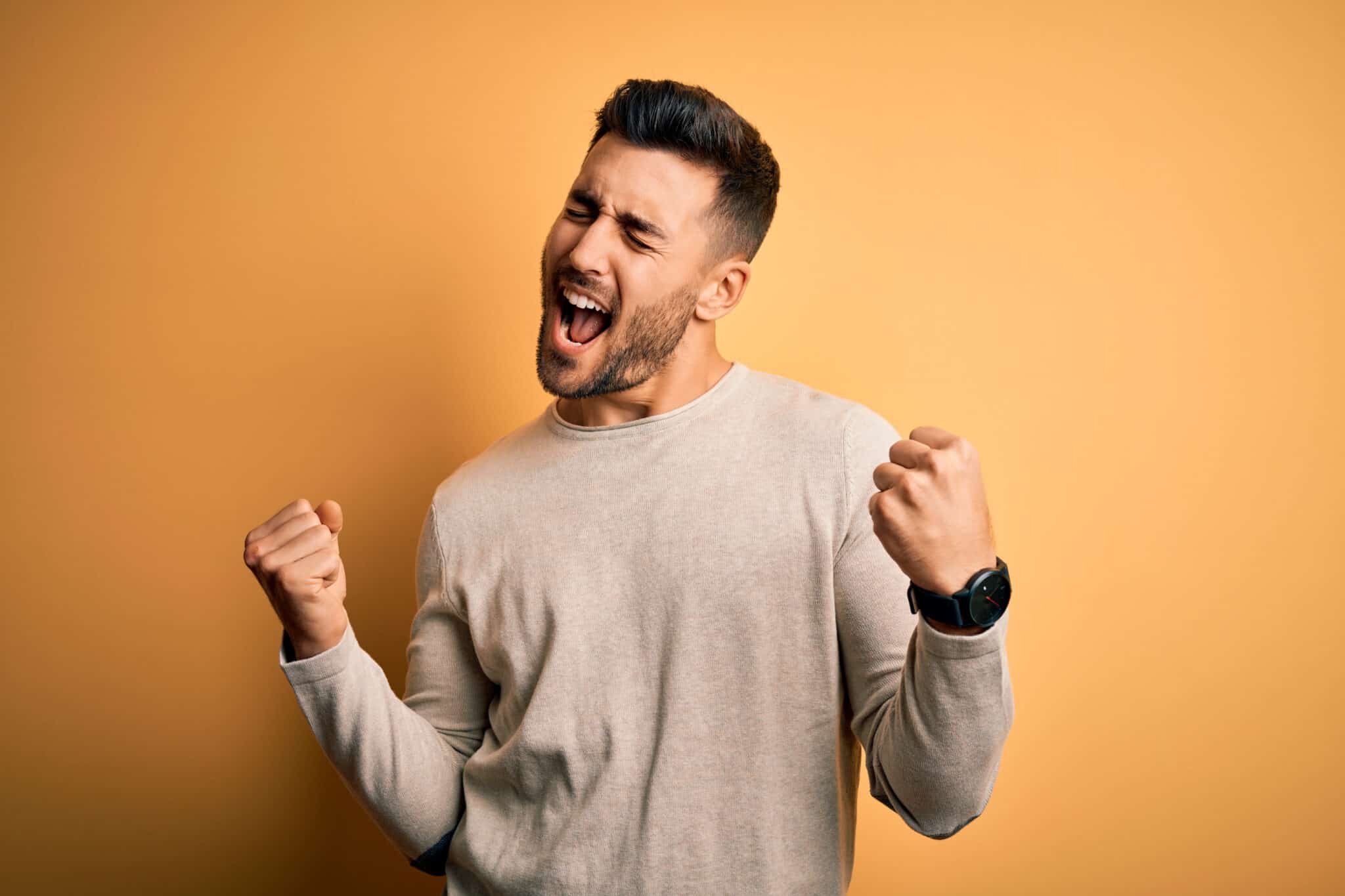 Photo Of Charming Young Man Dressed Blue Sweater Laughing Arm