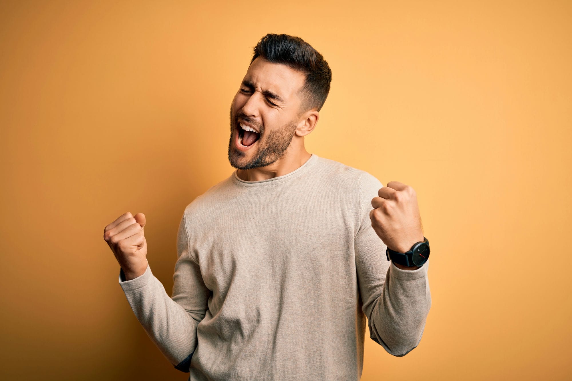 Young Handsome Man Wearing Casual Sweater Standing Over Isolated Yellow