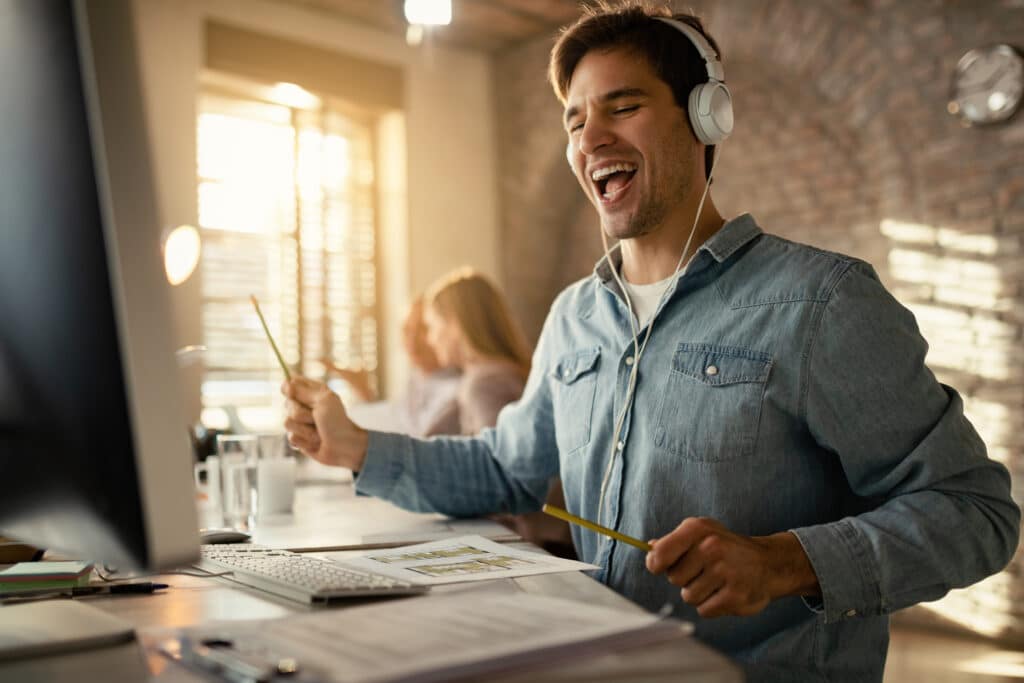 Happy Freelance Worker Having Fun While Working At Office Desk