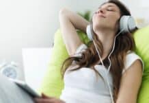 Woman Listening To Music In Ipad