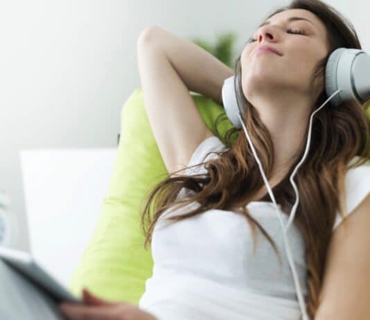 Woman Listening To Music In Ipad