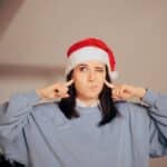 12 Christmas Songs That Make Us Want to Scream Stressed Woman Covering Her Ears Tired Of Christmas Songs. Neighbor