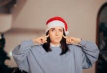 Stressed Woman Covering Her Ears Tired Of Christmas Songs. Neighbor